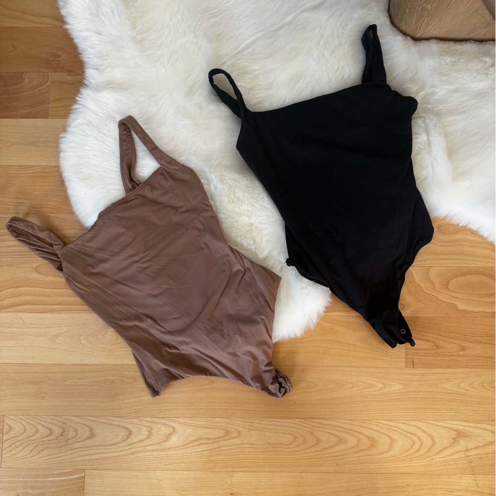 Skims Bodysuit Bundle in black and tan.